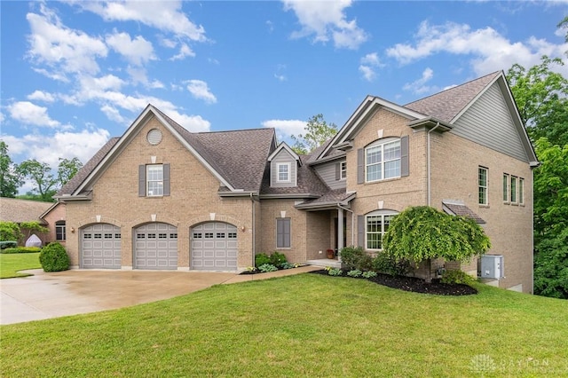 3190 Fox Run Dr, Hamilton, OH 45013 - traditional home with driveway, brick siding, an attached garage, and a front yard