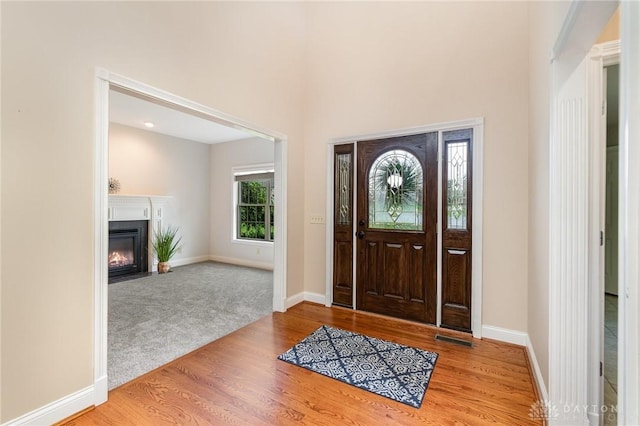 3190 Fox Run Dr, Hamilton, OH 45013 - carpeted entrance foyer featuring wood finished floors and a fireplace with flush hearth