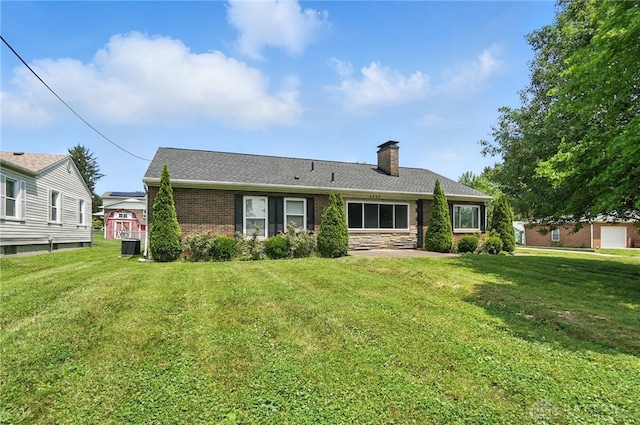 4503 Central Ave, Middletown, OH 45044 - back of house with a chimney, a lawn, and brick siding