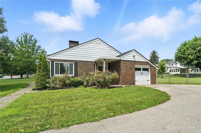 4503 Central Ave, Middletown, OH 45044 - view of front of property with a chimney, brick siding, driveway, and an attached garage
