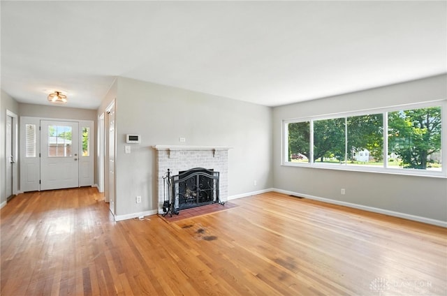 4503 Central Ave, Middletown, OH 45044 - unfurnished living room featuring light wood-style floors and a brick fireplace