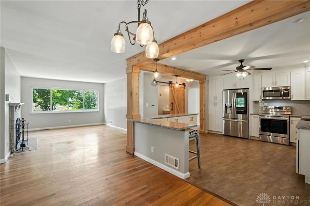 4503 Central Ave, Middletown, OH 45044 - kitchen featuring stainless steel appliances, white cabinetry, a ceiling fan, stone counters, and dark wood-style flooring