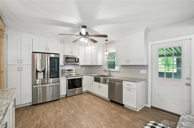 4503 Central Ave, Middletown, OH 45044 - kitchen featuring stainless steel appliances, tasteful backsplash, white cabinets, and wood finished floors