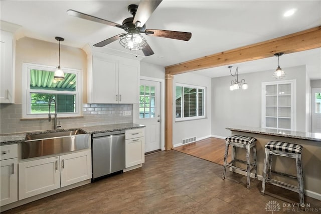 4503 Central Ave, Middletown, OH 45044 - kitchen with stainless steel dishwasher, backsplash, ceiling fan, stone countertops, and beamed ceiling