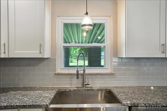 4503 Central Ave, Middletown, OH 45044 - kitchen featuring white cabinets, dark stone counters, tasteful backsplash, and hanging light fixtures