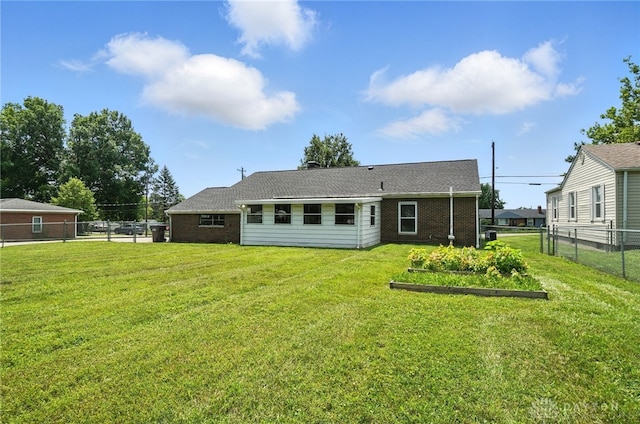 4503 Central Ave, Middletown, OH 45044 - back of house with brick siding and a vegetable garden