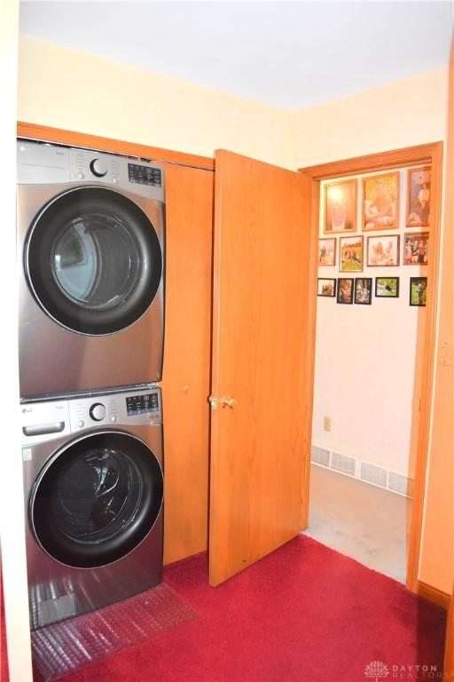 3235 W Ziegler Rd, Piqua, OH 45356 - washroom with stacked washing machine and dryer and carpet flooring