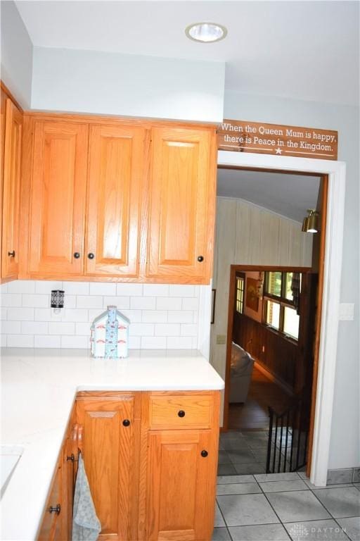 3235 W Ziegler Rd, Piqua, OH 45356 - kitchen with decorative backsplash, light countertops, and light tile patterned floors