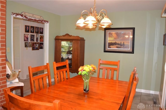 3235 W Ziegler Rd, Piqua, OH 45356 - tiled dining space featuring a chandelier and baseboards