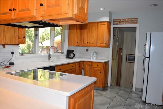 3235 W Ziegler Rd, Piqua, OH 45356 - kitchen featuring freestanding refrigerator, backsplash, light tile patterned flooring, light countertops, and brown cabinetry