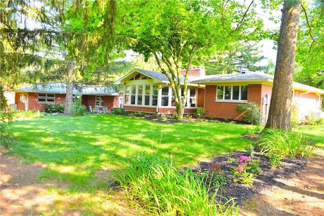 3235 W Ziegler Rd, Piqua, OH 45356 - view of front facade featuring brick siding and a front lawn