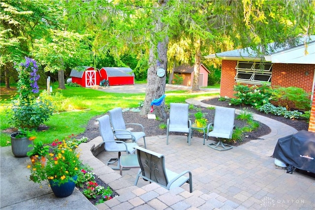3235 W Ziegler Rd, Piqua, OH 45356 - view of patio featuring a storage shed and a grill