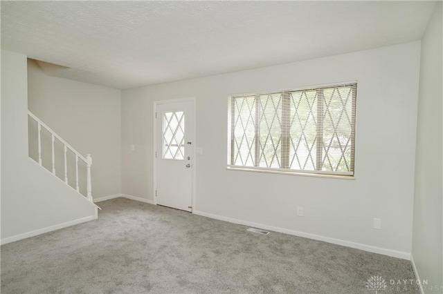 9446 Haddington Ct Unit 200, Cincinnati, OH 45251 - carpeted entrance foyer with stairway and a textured ceiling