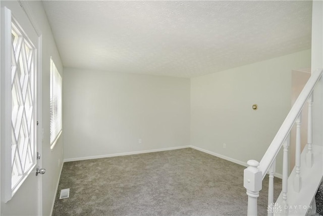 9446 Haddington Ct Unit 200, Cincinnati, OH 45251 - unfurnished room featuring carpet flooring, a textured ceiling, and stairs