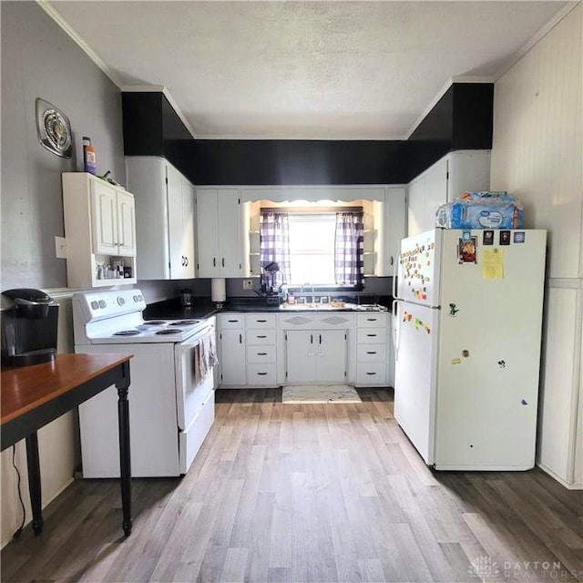 300 S Evans St, Saratoga, IN 47382 - kitchen featuring white appliances, crown molding, light wood-type flooring, white cabinets, and dark countertops