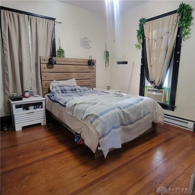 300 S Evans St, Saratoga, IN 47382 - bedroom with a baseboard heating unit, wood finished floors, and cooling unit