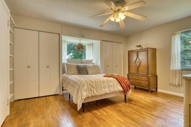 3318 US Route 42, Cedarville Twp, OH 45314 - bedroom with multiple closets, light wood-style flooring, and a ceiling fan