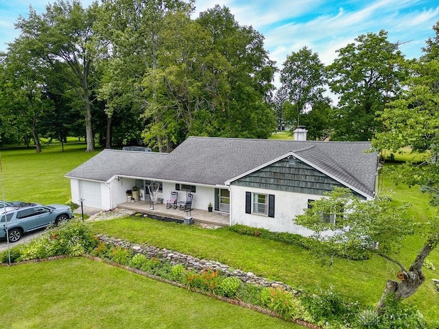 3318 US Route 42, Cedarville Twp, OH 45314 - view of front of house featuring an attached garage, a front yard, driveway, and view of scattered trees