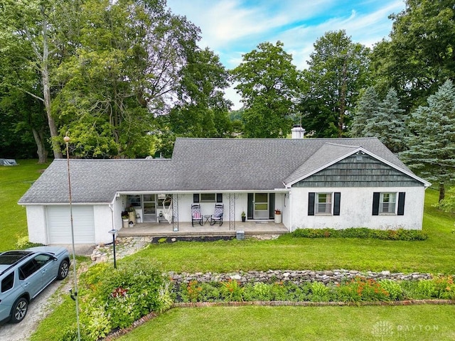 3318 US Route 42, Cedarville Twp, OH 45314 - ranch-style house with an attached garage, a porch, a front lawn, stucco siding, and a chimney