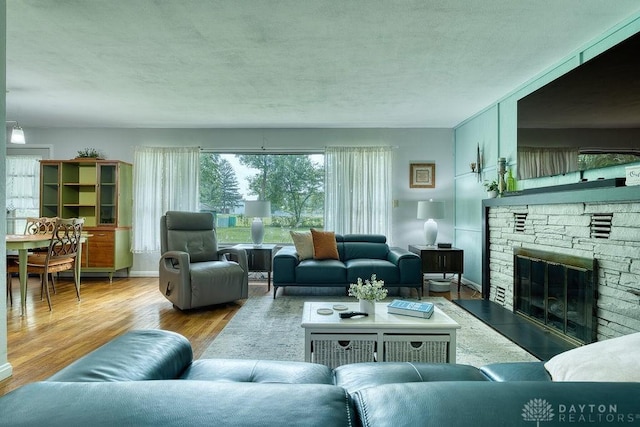 3318 US Route 42, Cedarville Twp, OH 45314 - living area with a fireplace, wood finished floors, and a textured ceiling