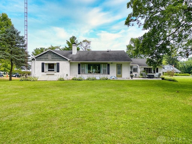 3318 US Route 42, Cedarville Twp, OH 45314 - view of front of property with a chimney, a front lawn, a patio, and stucco siding