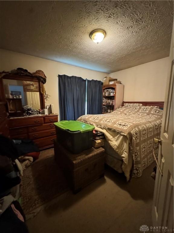 8211 Sue Ave, Franklin, OH 45005 - bedroom featuring a textured ceiling and carpet floors