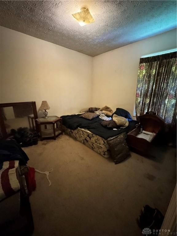 8211 Sue Ave, Franklin, OH 45005 - carpeted bedroom with a textured ceiling