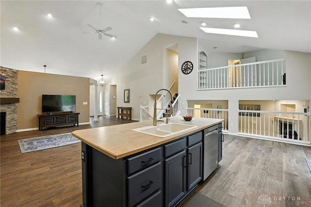 2210 Hidden Woods Blvd, Beavercreek, OH 45431 - kitchen with high vaulted ceiling, dishwasher, open floor plan, a ceiling fan, and a stone fireplace
