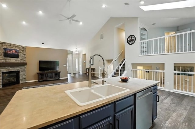 2210 Hidden Woods Blvd, Beavercreek, OH 45431 - kitchen featuring dishwasher, high vaulted ceiling, a ceiling fan, a fireplace, and dark wood-type flooring