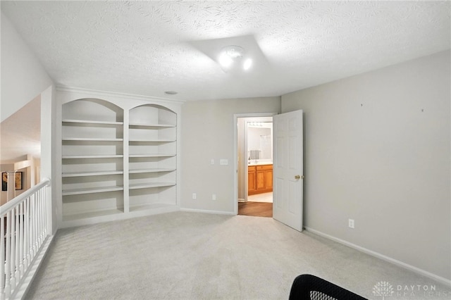 2210 Hidden Woods Blvd, Beavercreek, OH 45431 - unfurnished bedroom with light colored carpet, a textured ceiling, and a closet