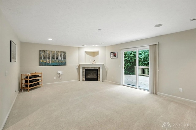 2210 Hidden Woods Blvd, Beavercreek, OH 45431 - unfurnished living room featuring carpet, a glass covered fireplace, and recessed lighting