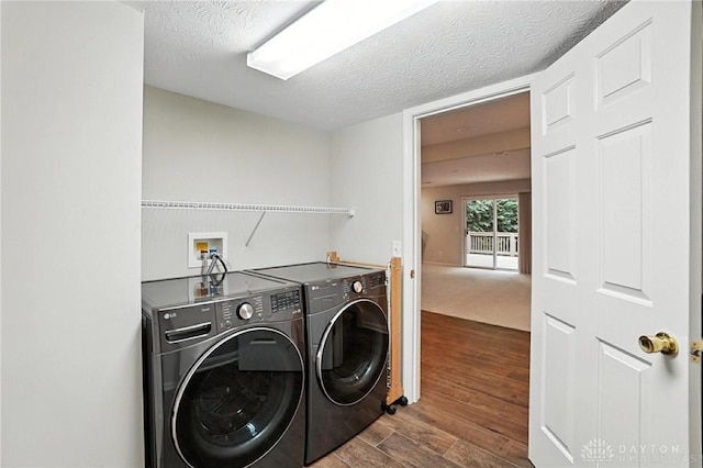 2210 Hidden Woods Blvd, Beavercreek, OH 45431 - laundry room featuring washer and clothes dryer, dark wood-type flooring, and a textured ceiling