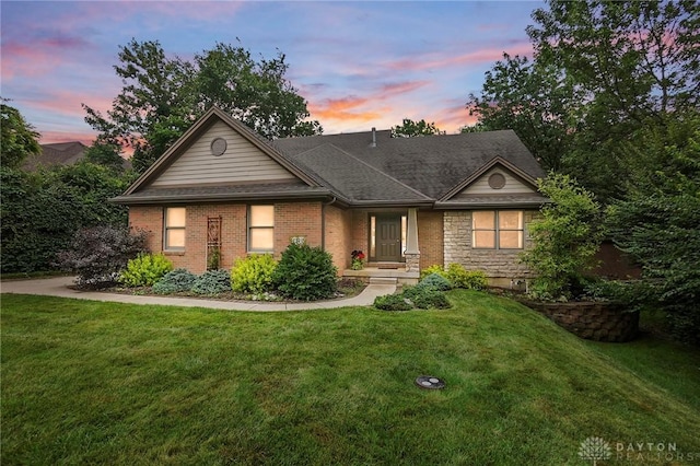 2210 Hidden Woods Blvd, Beavercreek, OH 45431 - view of front of house with a yard, stone siding, and roof with shingles