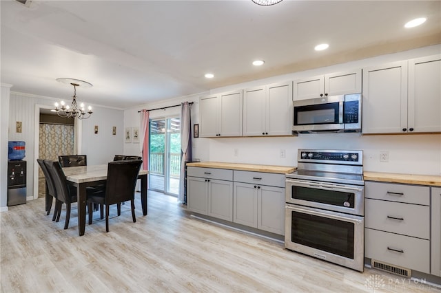 11920 State Route 725, Germantown, OH 45327 - kitchen with stainless steel appliances, wood counters, gray cabinetry, crown molding, and a chandelier