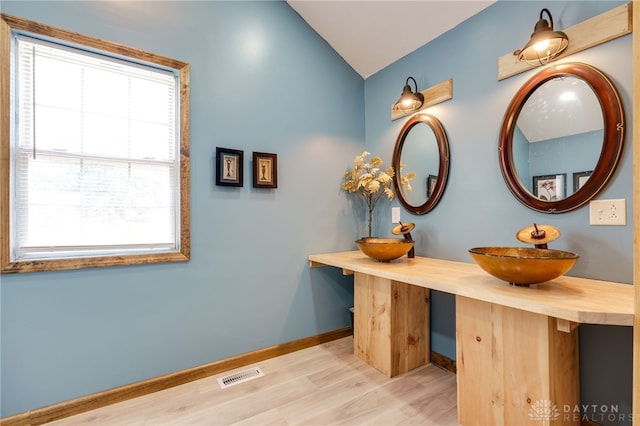 11920 State Route 725, Germantown, OH 45327 - bathroom featuring plenty of natural light, lofted ceiling, wood finished floors, and double vanity