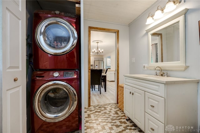 11920 State Route 725, Germantown, OH 45327 - laundry area featuring stacked washer / dryer, a chandelier, light flooring, and ornamental molding