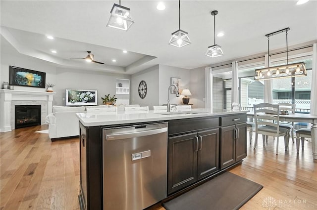 539 Bellasera Dr, Sugarcreek Twp, OH 45440 - kitchen featuring stainless steel dishwasher, light wood-style floors, light countertops, a tray ceiling, and ceiling fan