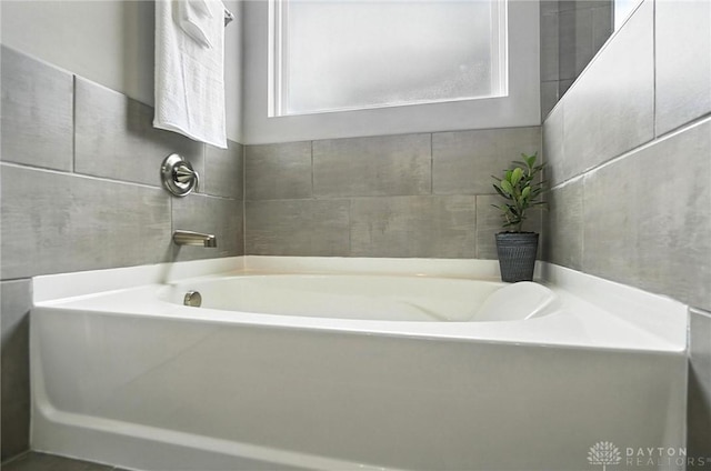 539 Bellasera Dr, Sugarcreek Twp, OH 45440 - bathroom featuring a garden tub and tile walls