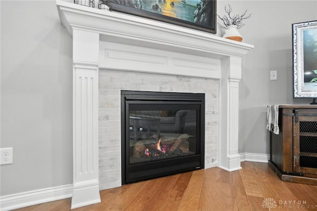 539 Bellasera Dr, Sugarcreek Twp, OH 45440 - detailed view of wood finished floors and a brick fireplace
