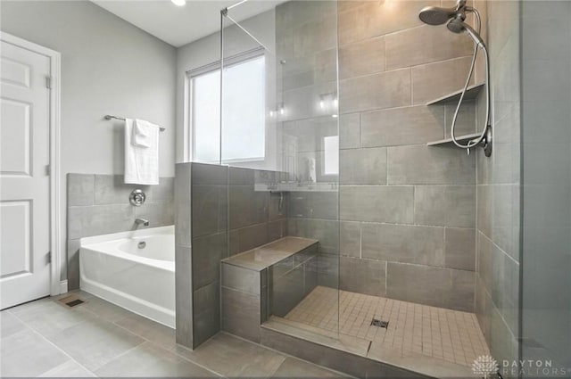 539 Bellasera Dr, Sugarcreek Twp, OH 45440 - bathroom featuring a shower stall, a garden tub, and tile patterned flooring