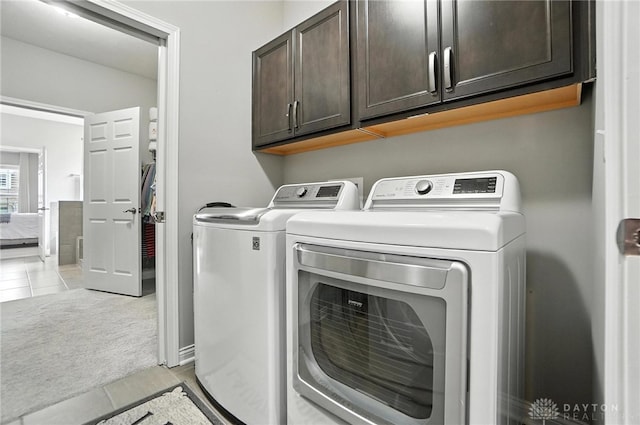 539 Bellasera Dr, Sugarcreek Twp, OH 45440 - laundry area featuring cabinet space, light tile patterned floors, and separate washer and dryer