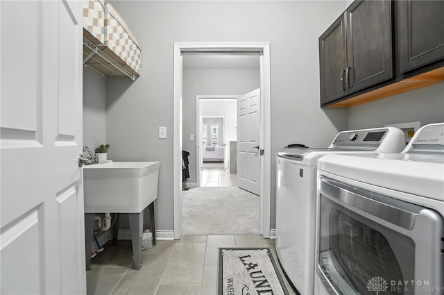 539 Bellasera Dr, Sugarcreek Twp, OH 45440 - laundry room featuring separate washer and dryer, cabinet space, and light carpet