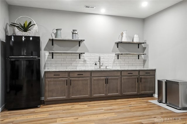 539 Bellasera Dr, Sugarcreek Twp, OH 45440 - bar area featuring freestanding refrigerator, decorative backsplash, light wood-style flooring, and recessed lighting