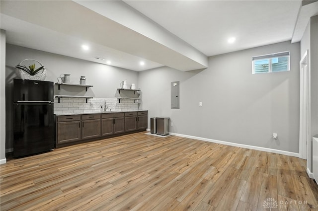 539 Bellasera Dr, Sugarcreek Twp, OH 45440 - bar with freestanding refrigerator, light wood finished floors, decorative backsplash, electric panel, and recessed lighting