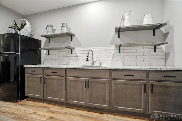 539 Bellasera Dr, Sugarcreek Twp, OH 45440 - kitchen with open shelves, freestanding refrigerator, tasteful backsplash, and dark brown cabinets