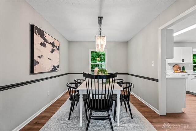 4182 Fox Fern Ct, Beavercreek, OH 45432 - dining room featuring wood finished floors, plenty of natural light, and a chandelier