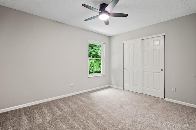 4182 Fox Fern Ct, Beavercreek, OH 45432 - unfurnished bedroom featuring carpet floors, a closet, a textured ceiling, and ceiling fan