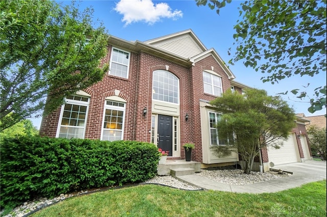 4546 Brackenview Ct, Mason, OH 45040 - view of front of home with concrete driveway, an attached garage, brick siding, and a front lawn