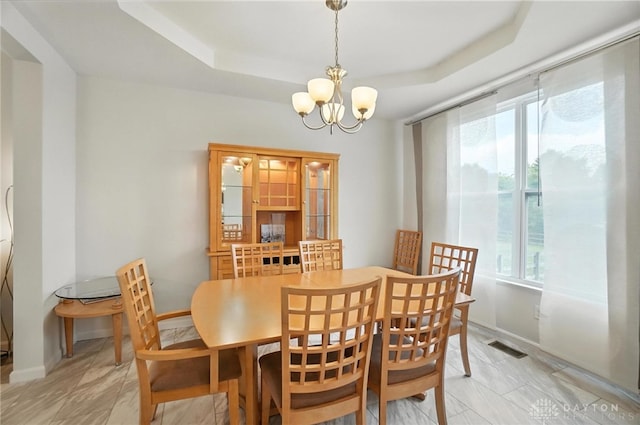 4546 Brackenview Ct, Mason, OH 45040 - dining area featuring healthy amount of natural light, a chandelier, and a tray ceiling