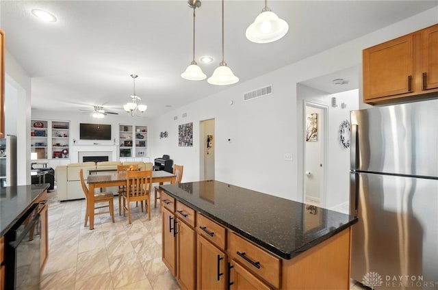 4546 Brackenview Ct, Mason, OH 45040 - kitchen with freestanding refrigerator, a fireplace, a ceiling fan, built in features, and a center island